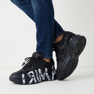 Black Amiri chunky sneakers with white painted graffiti on sole and upper