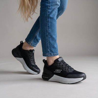 black Skechers trainers with white midsole and knit upper