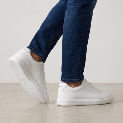Calvin Klein white low-top sneakers with rubber sole and subtle branding