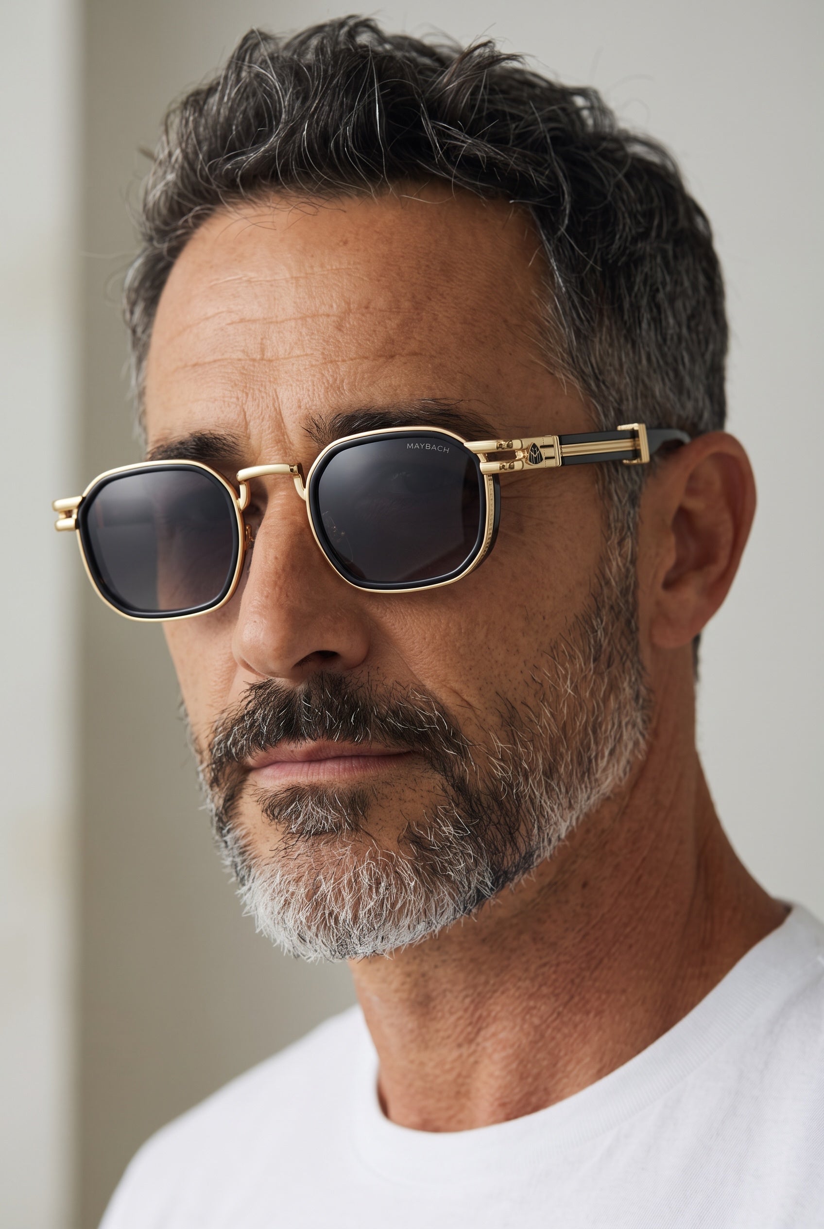 Maybach gold-trim sunglasses with black lenses worn by a man