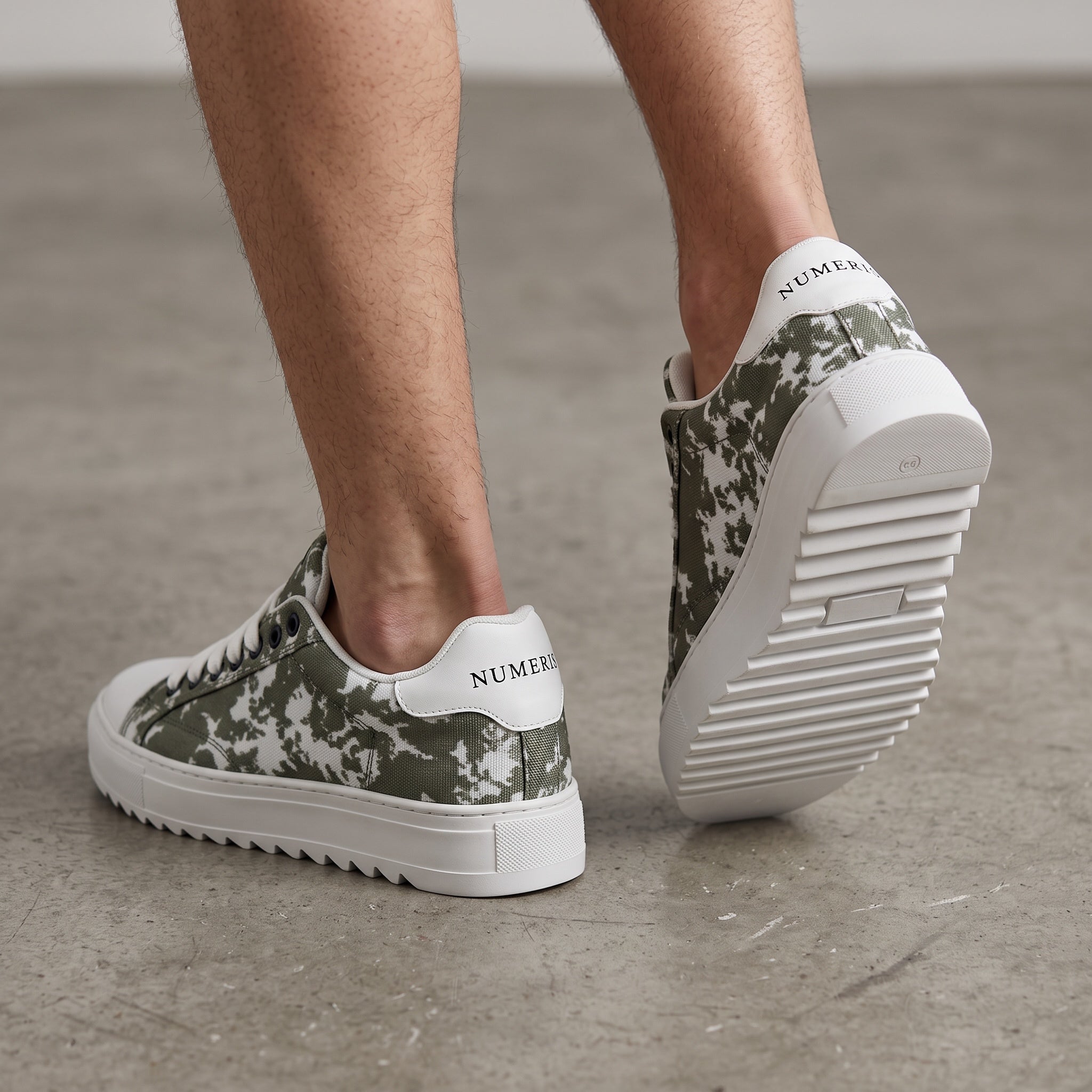 Numeris low-top green camo sneakers with white sole and serrated outsole