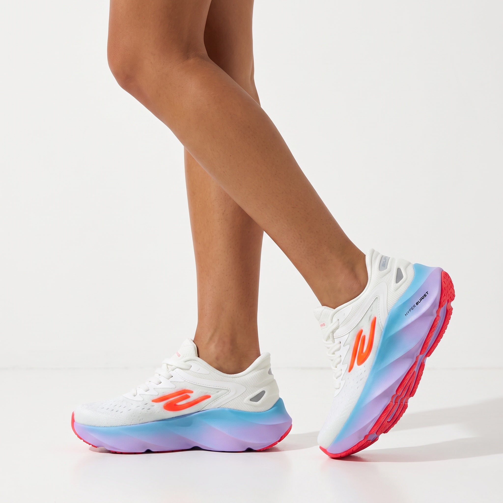 white Skechers-style sneakers with blue-purple gradient sole and neon orange accents