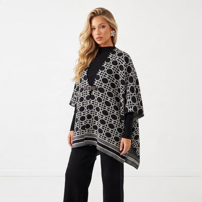 Black geometric patterned poncho with front buckle on model
