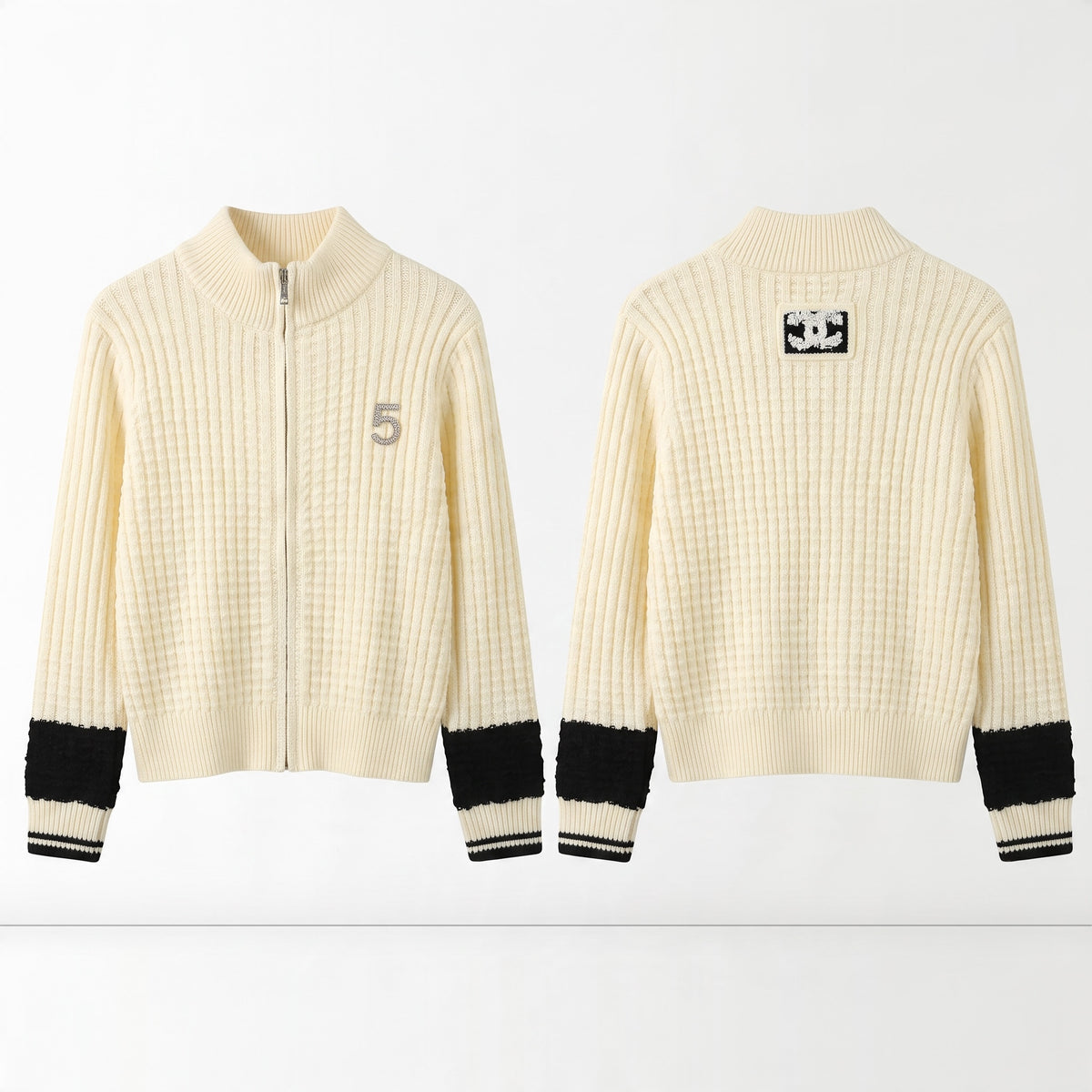 Cream ribbed zip cardigan with black cuff bands and Chanel CC patch on back