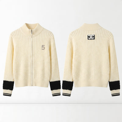 Cream ribbed zip cardigan with black cuff bands and Chanel CC patch on back