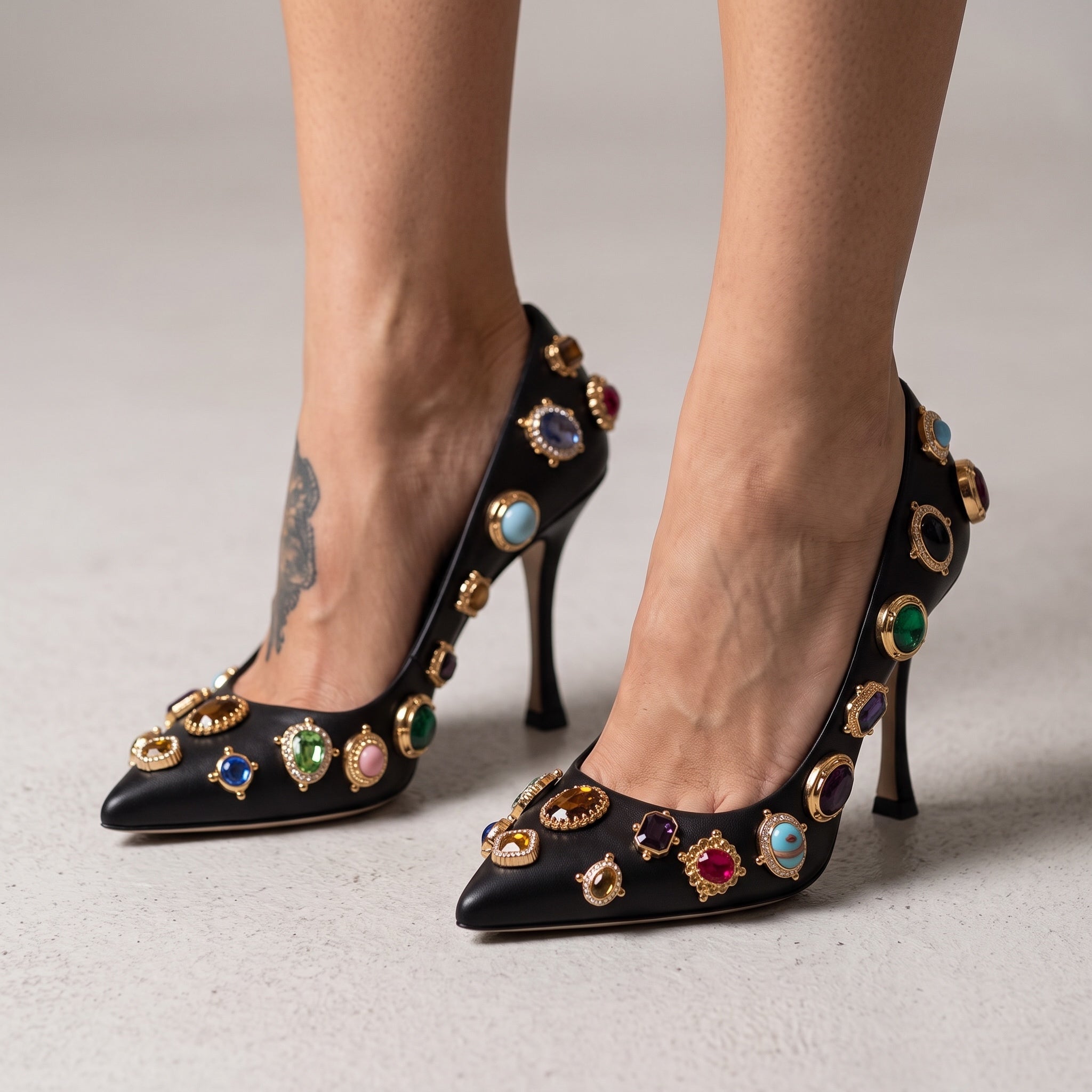 black pointed-toe pumps with multicolour jewel embellishments and gold settings