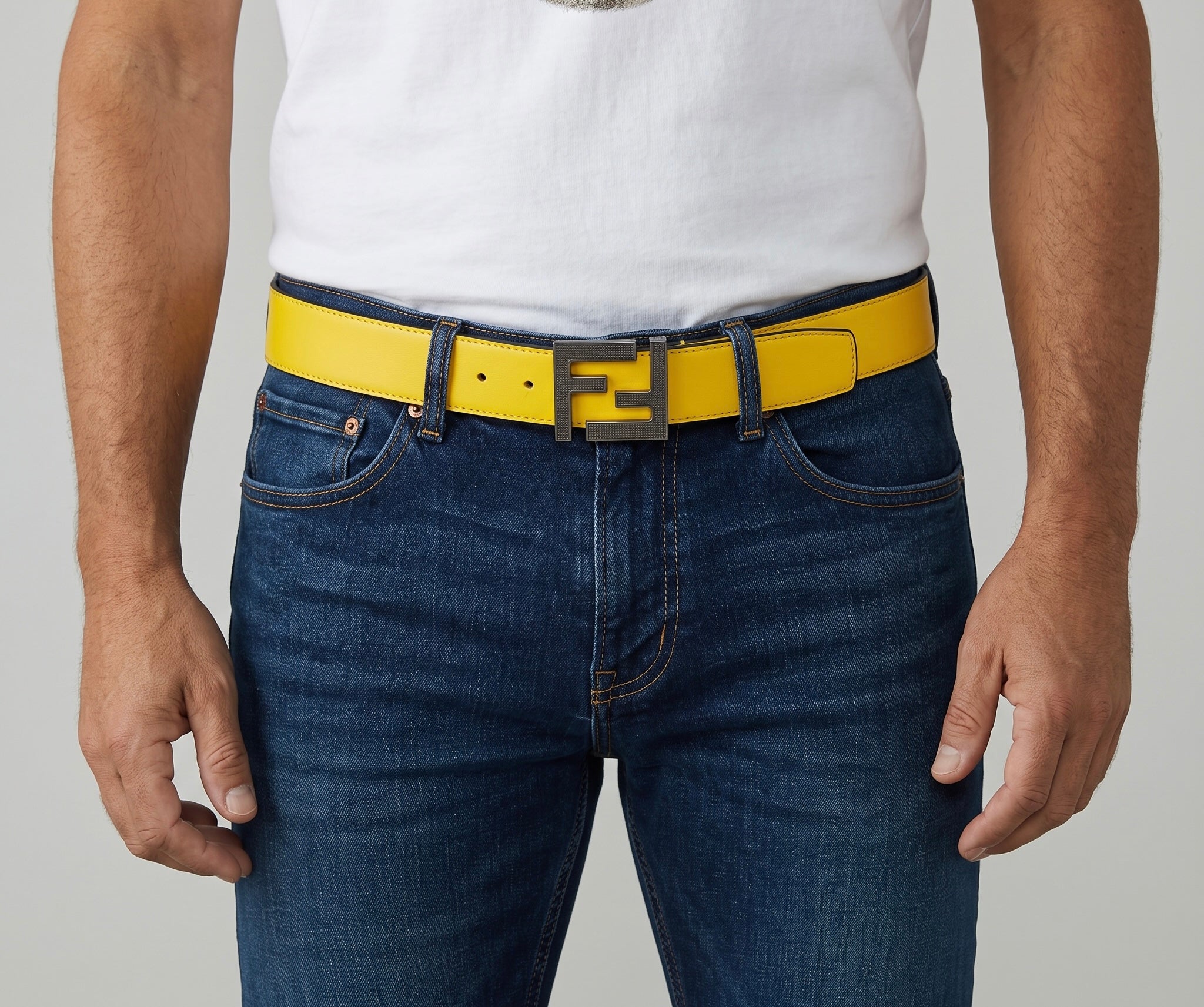 Yellow Fendi belt with double F buckle worn with jeans.