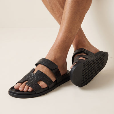 Hermès black croc-embossed men's slide sandal with adjustable ankle strap and chunky sole