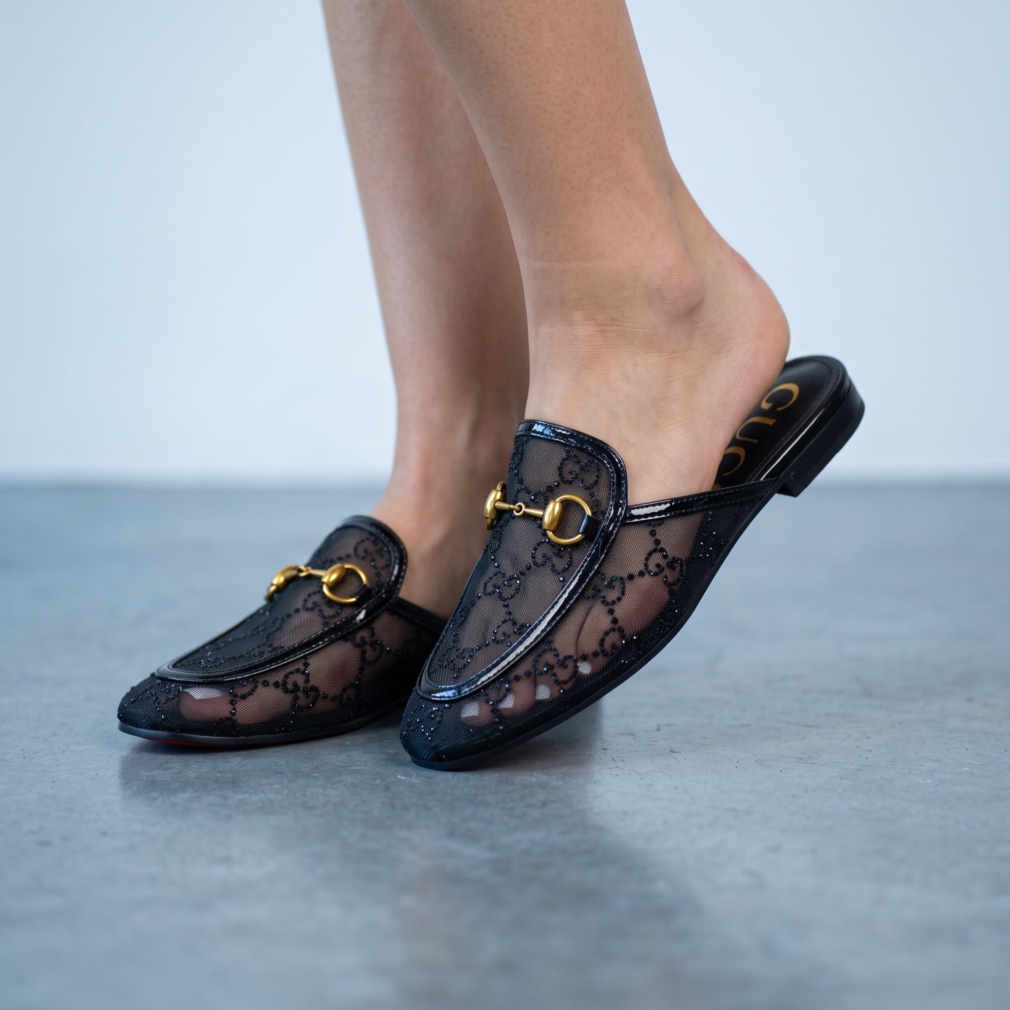black Gucci mesh mule loafer with gold horsebit hardware