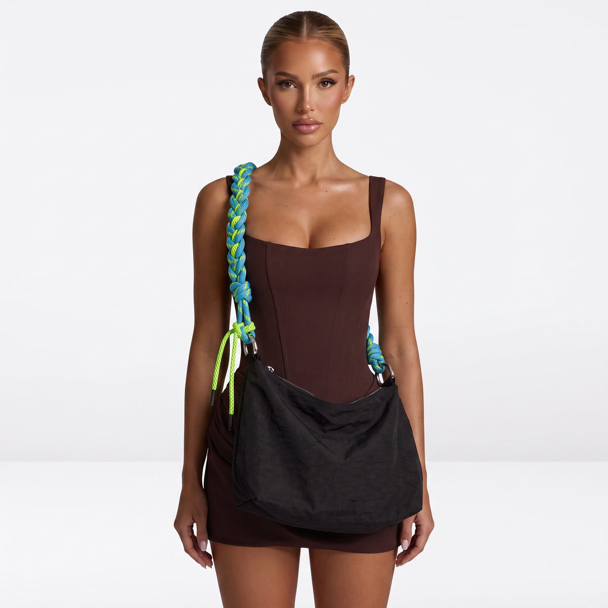 Black nylon hobo bag with braided blue and green rope strap and silver rings