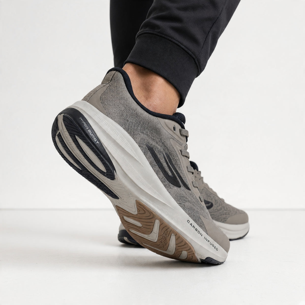 pair of grey Skechers trainers with carbon-infused midsole