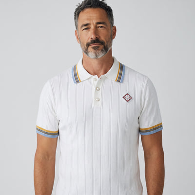 white ribbed short-sleeve polo with striped collar and chest badge