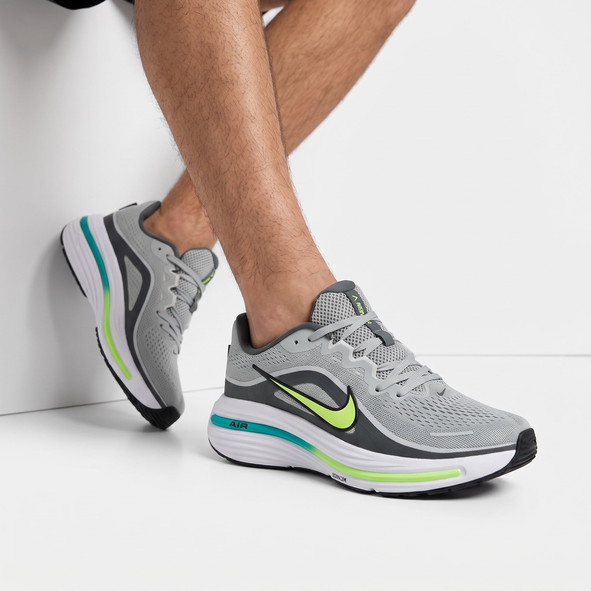 Grey Nike running sneakers with neon lime Swoosh and teal midsole accents