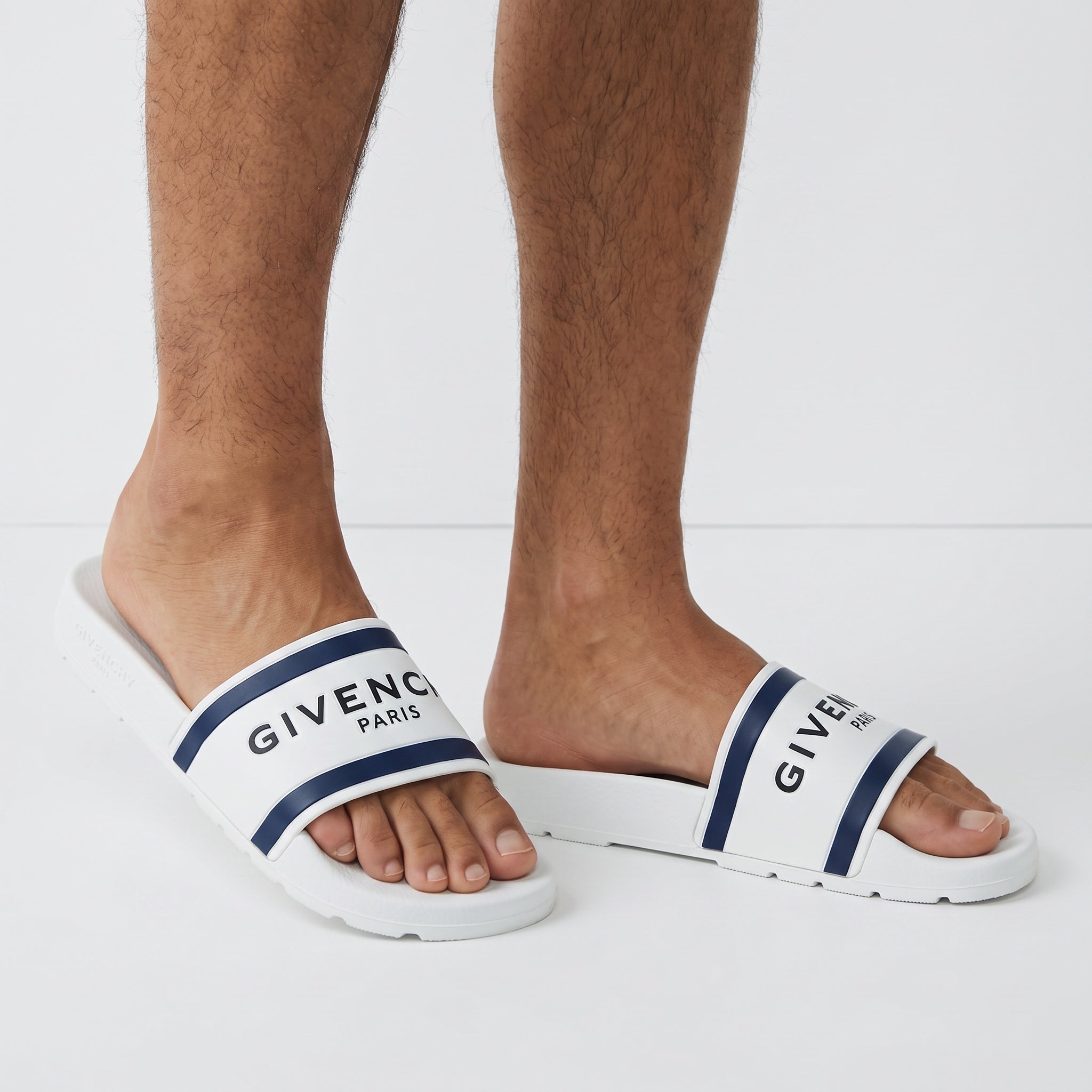 White Givenchy slide sandals with navy stripes and GIVENCHY PARIS logo on strap