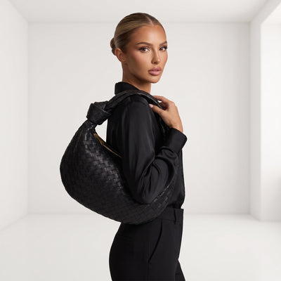 Black woven intrecciato hobo bag with knotted top handle and gold zipper