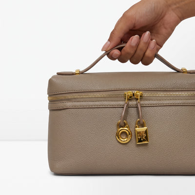 taupe top-handle bag with gold hardware and LP charm