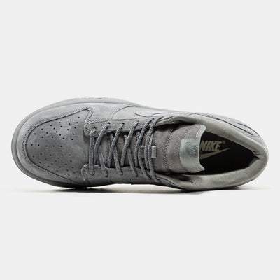 Grey Nike Dunk Low suede sneaker with small red Supreme box logo at heel