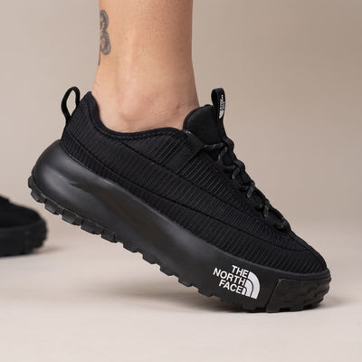 The North Face black trail sneaker with chunky lug sole and visible logo on midsole