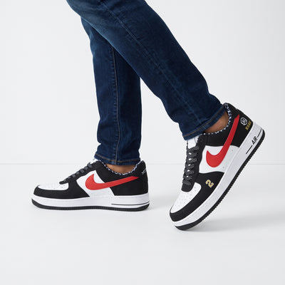 Nike Air Force 1 low-top sneakers in black white with orange Swoosh