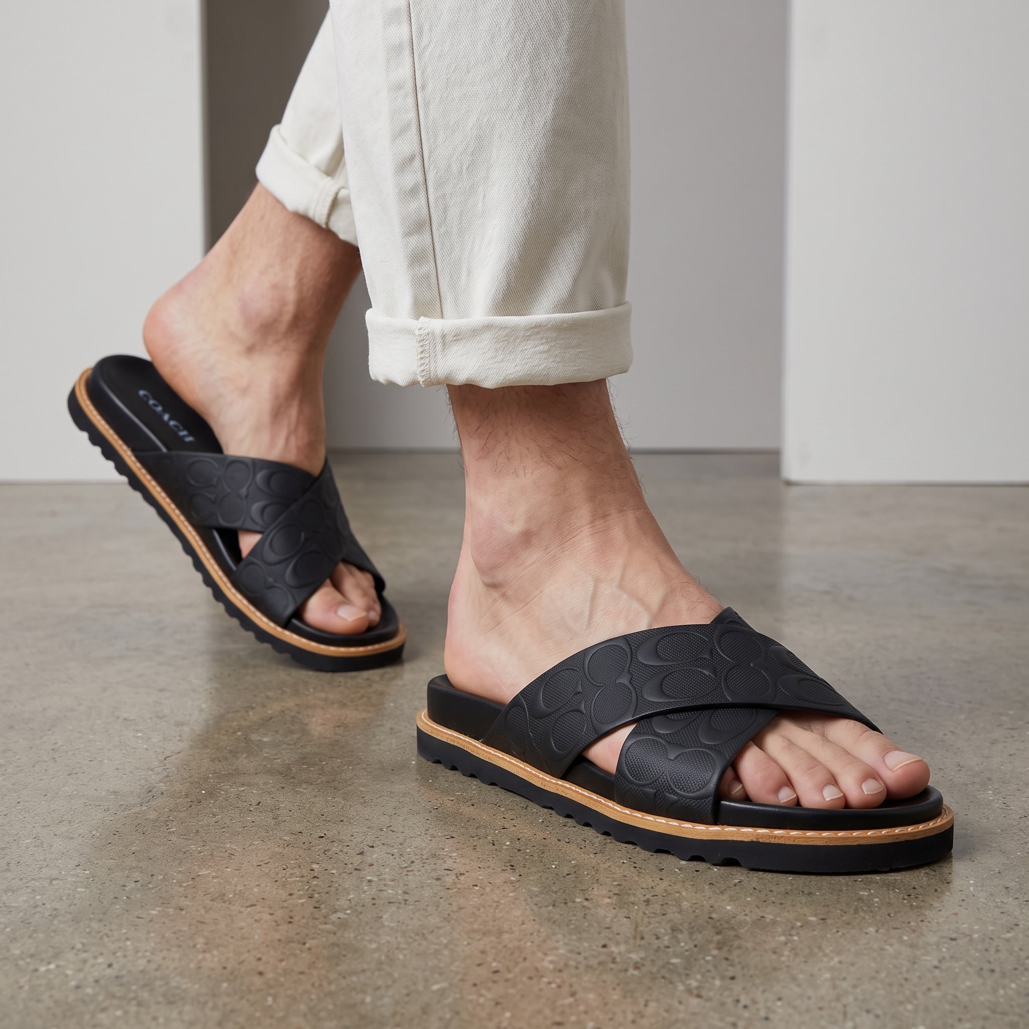 black Coach embossed logo crossover slide sandal with chunky treaded sole