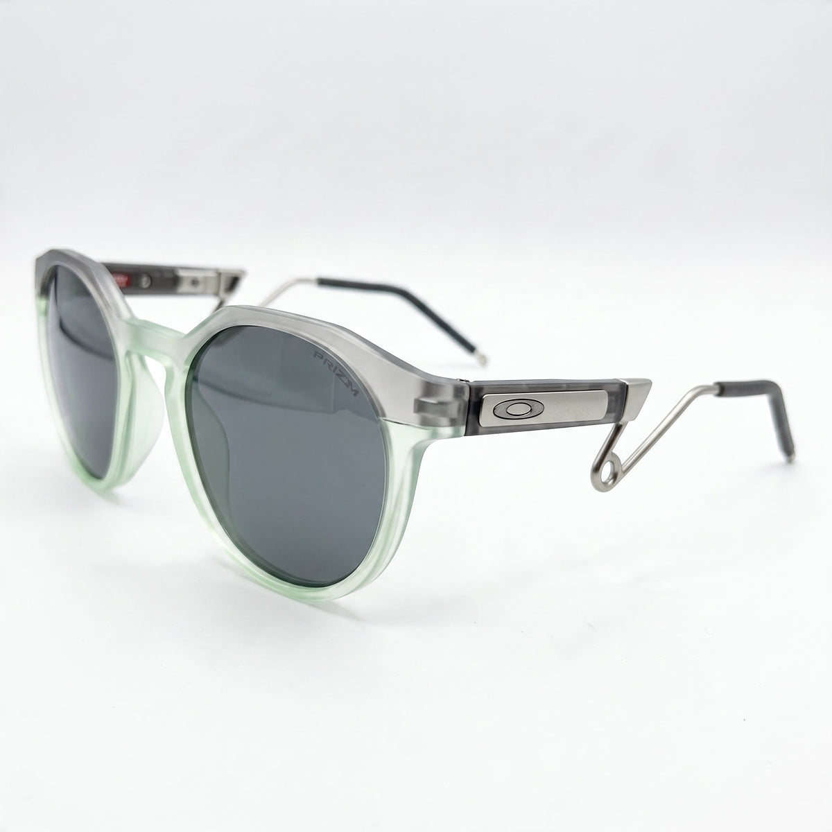 Oakley sunglasses with translucent mint frame and Prizm lenses, metal temples