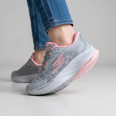 grey Skechers running sneaker with pink accents and chunky white midsole