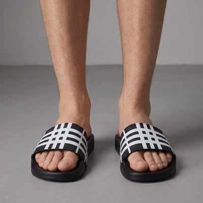 Burberry black and white check slide sandal on foot