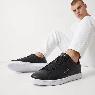 Tommy Hilfiger black low-top sneakers with white sole and perforated side