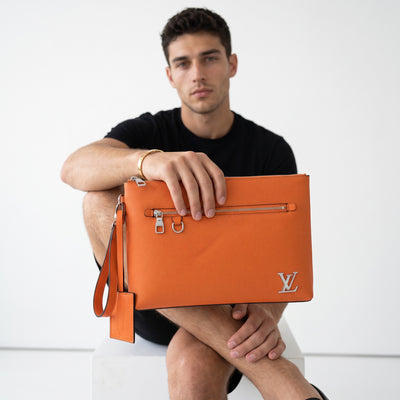 orange Louis Vuitton leather pouch with LV logo and front zip pocket