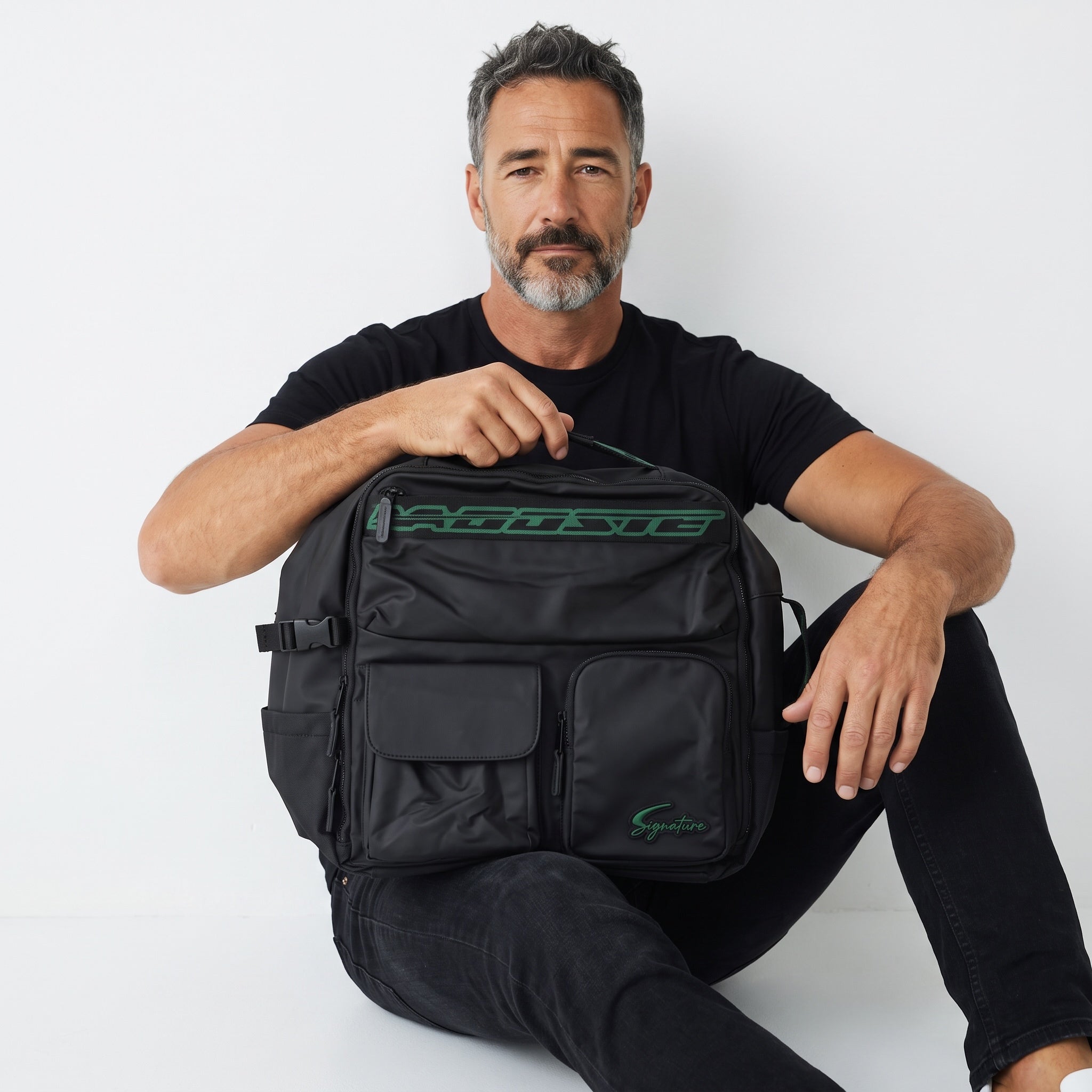 Black Lacoste backpack with green logo patches and multiple exterior pockets