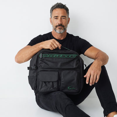 Black Lacoste backpack with green logo patches and multiple exterior pockets