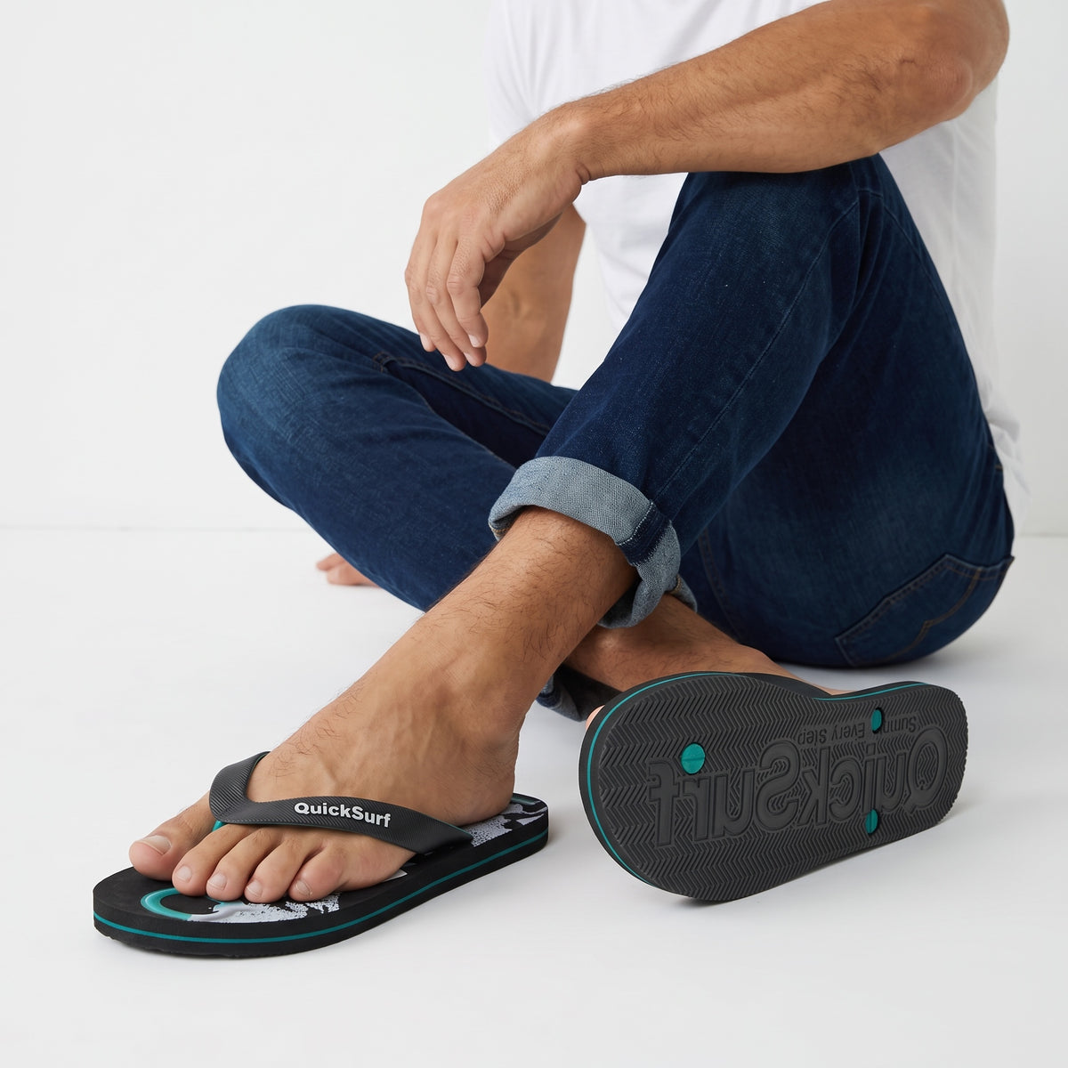 QuickSurf black and teal flip flops with graphic footbed and textured strap