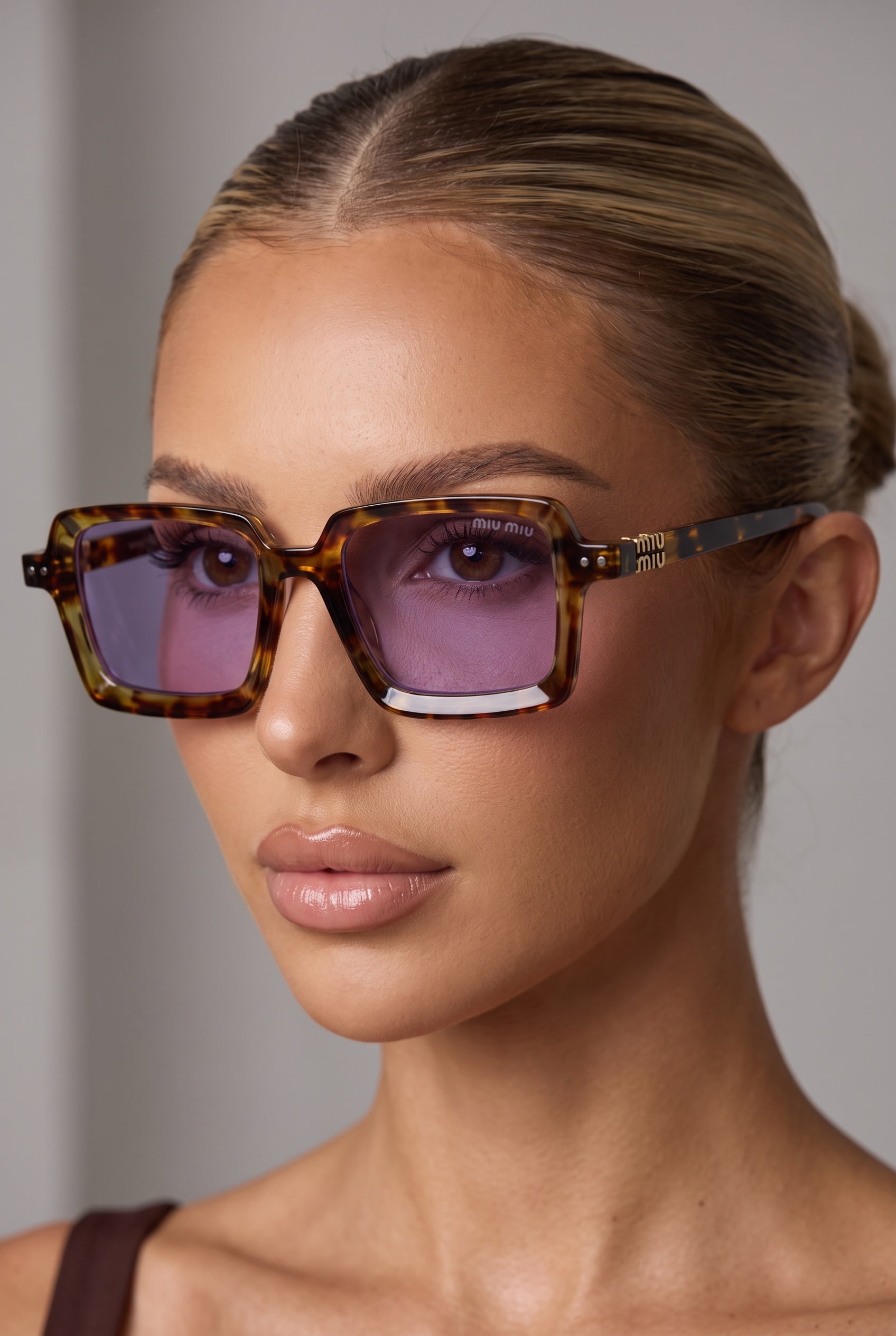 Miu Miu tortoiseshell square sunglasses with purple lenses on model
