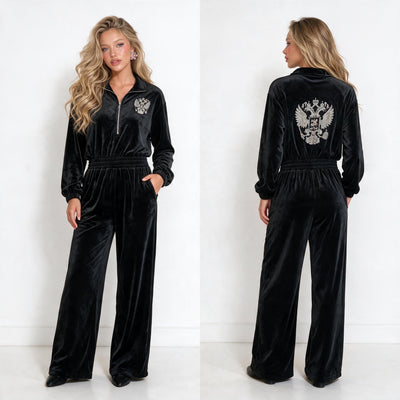 black velvet jumpsuit with half zip, elastic waist and embroidered crest on chest and back
