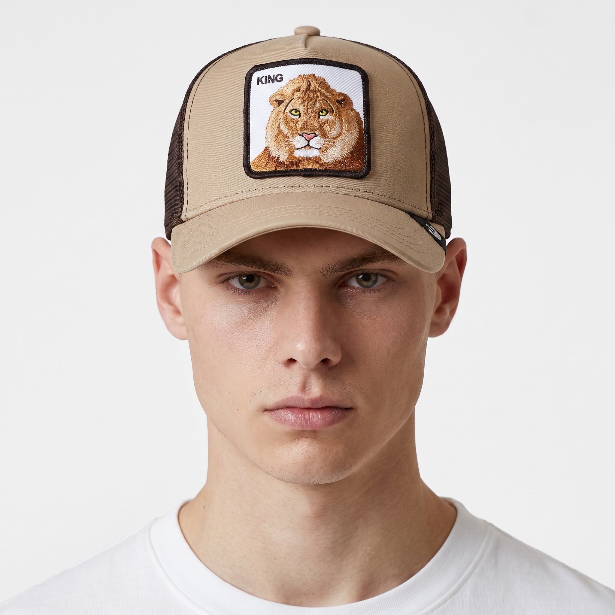 khaki trucker cap with embroidered lion patch and brown side panels