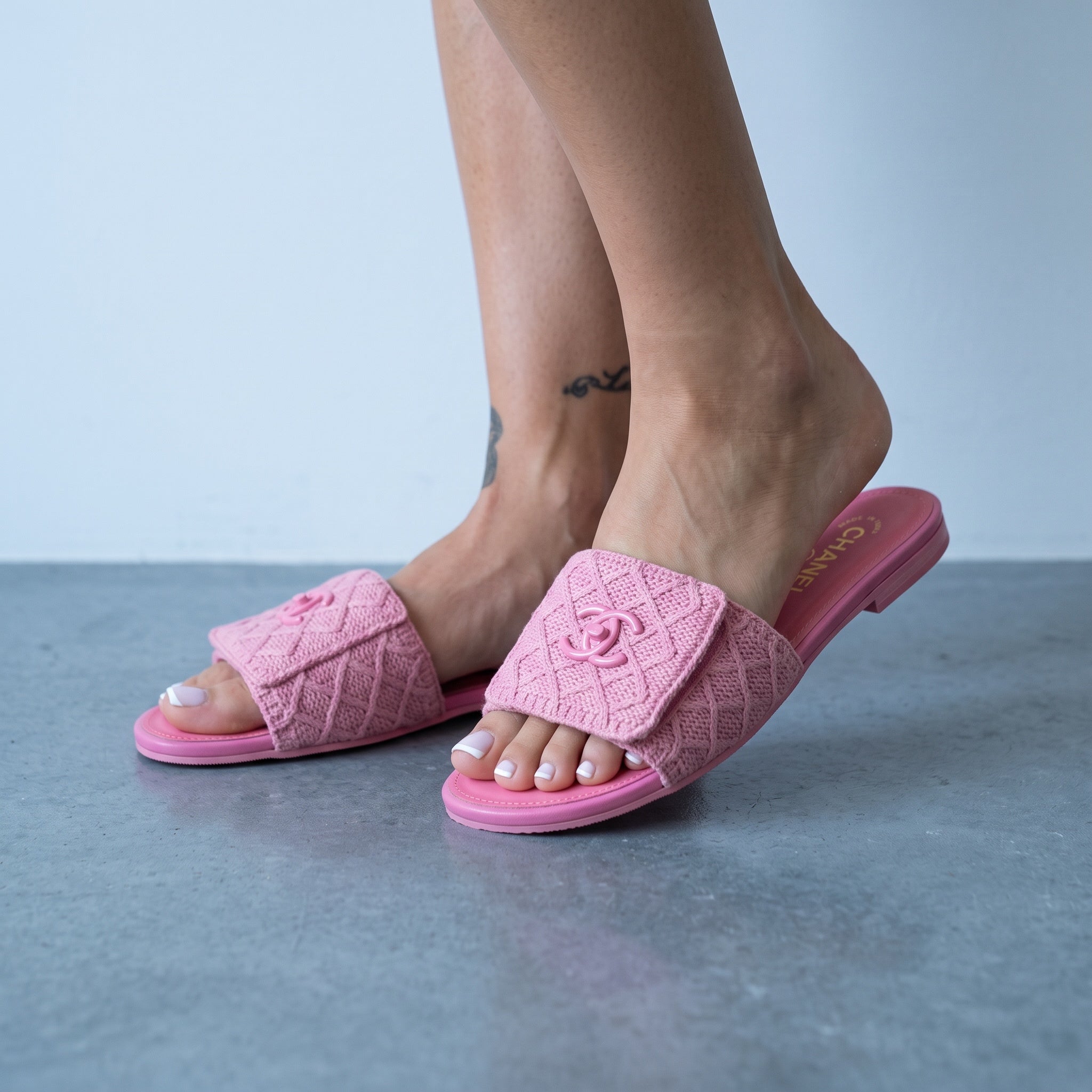pink quilted Chanel slide with CC logo on a footbed