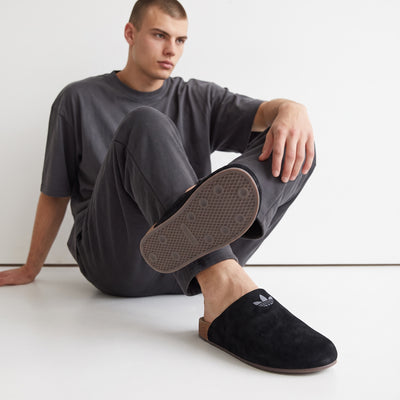 Adidas black slip-on mule with Trefoil logo and cork footbed