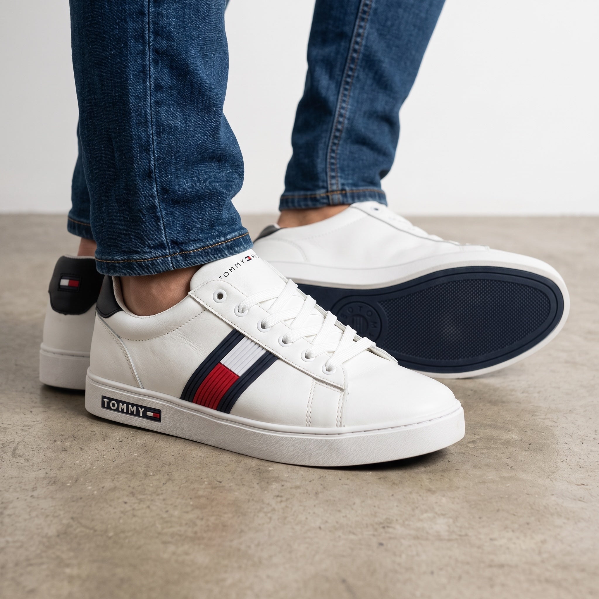 white Tommy Hilfiger low-top sneaker with navy and red stripe and branded midsole