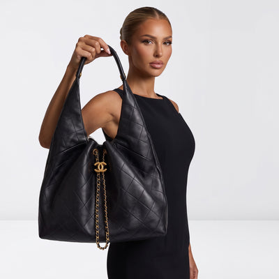 Black quilted Chanel hobo bag with gold CC charm and chain