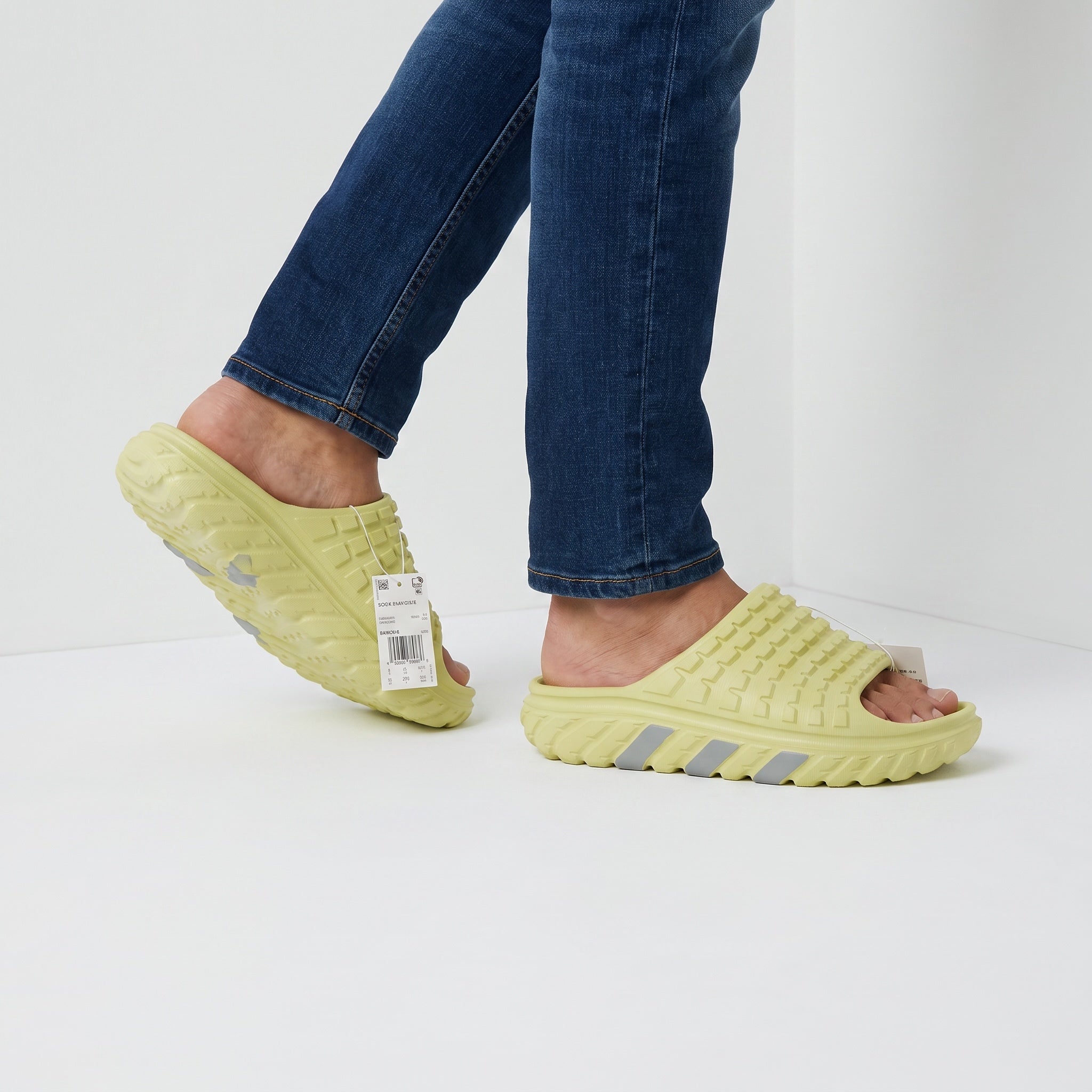 lemon yellow Adidas-style slip-on slides with textured upper and chunky treaded sole