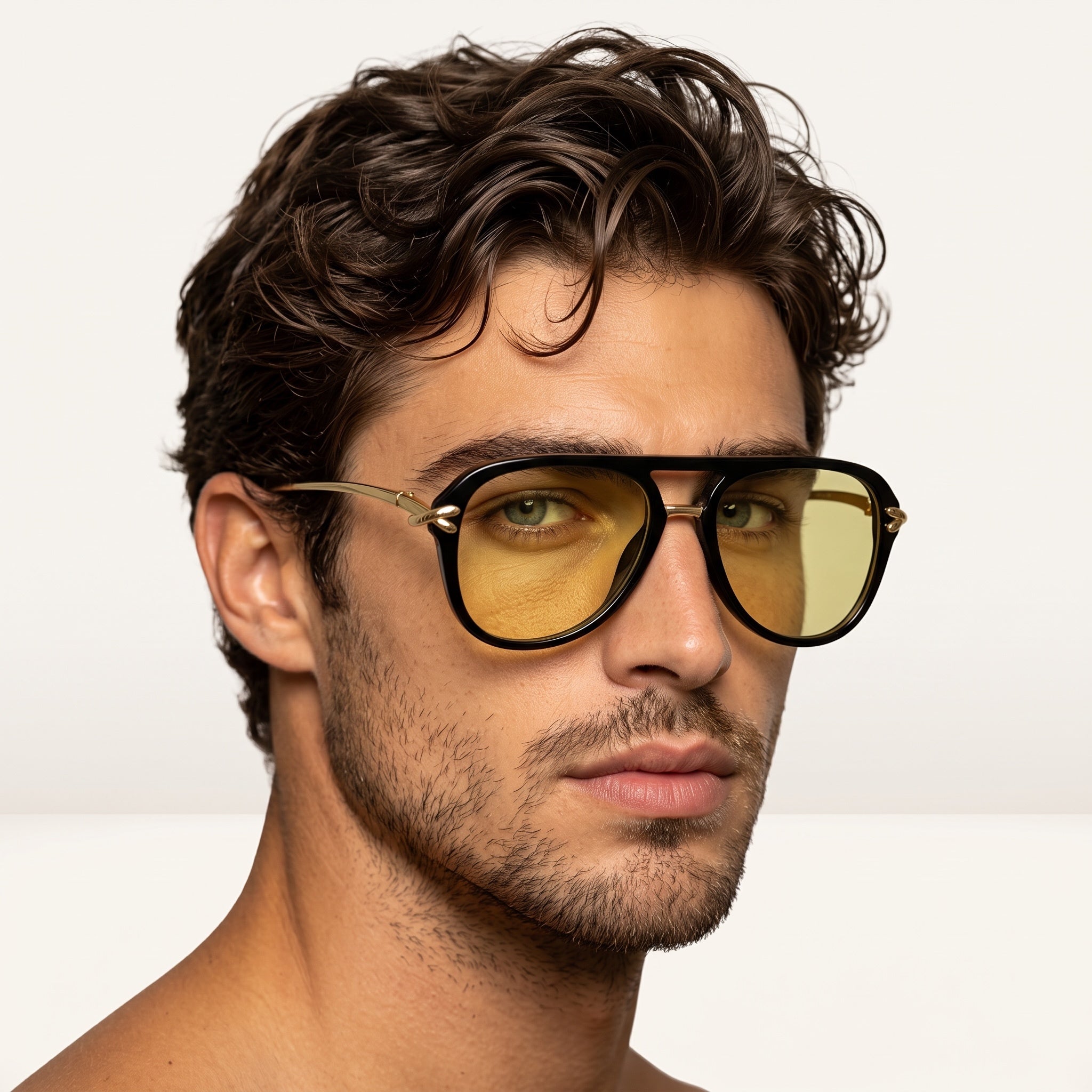 black frame sunglasses with amber yellow lenses and gold temples on male model