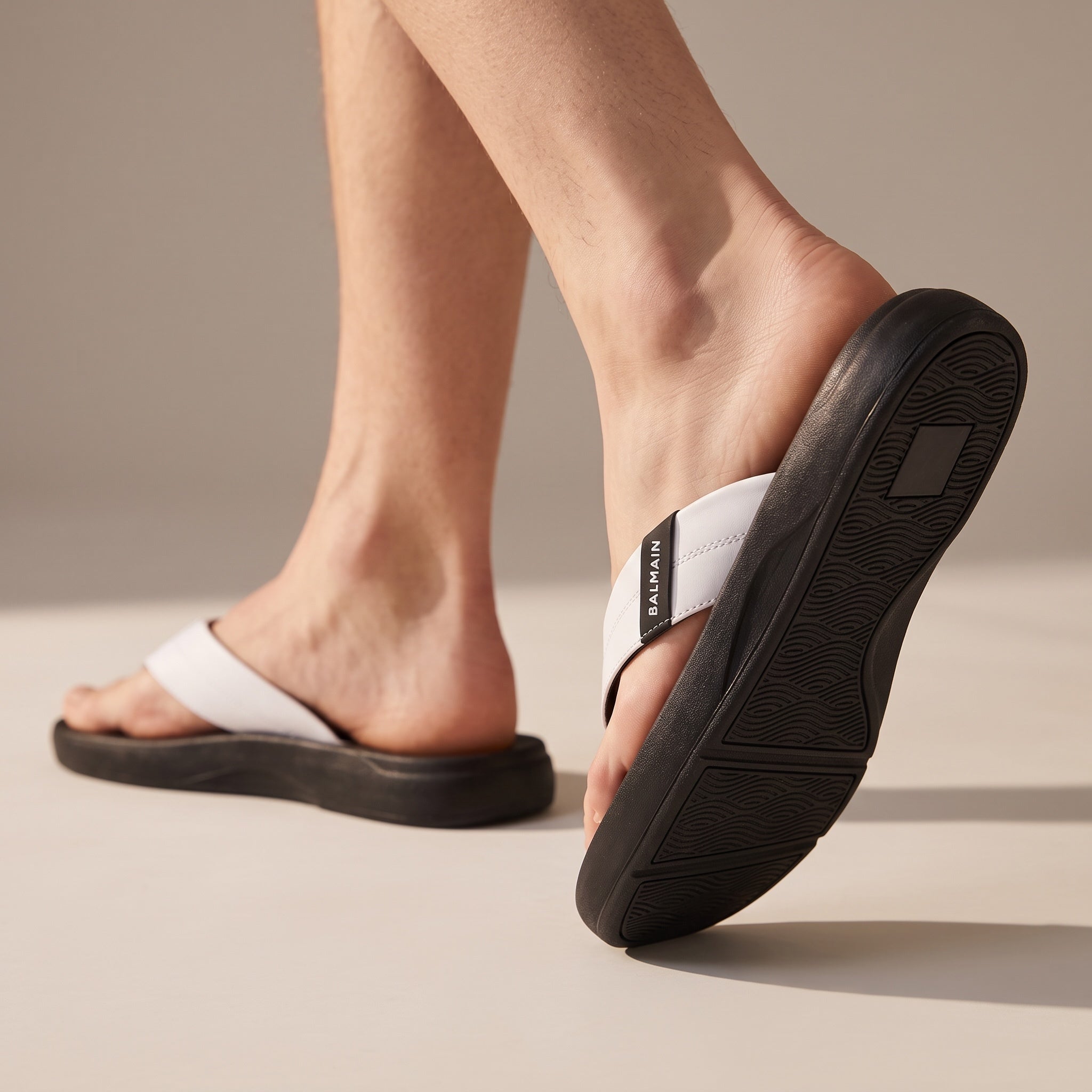 Balmain white strap flip-flops with black sole and Balmain logo on strap