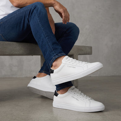 White low-top Calvin Klein sneakers with black heel tab and branded sole