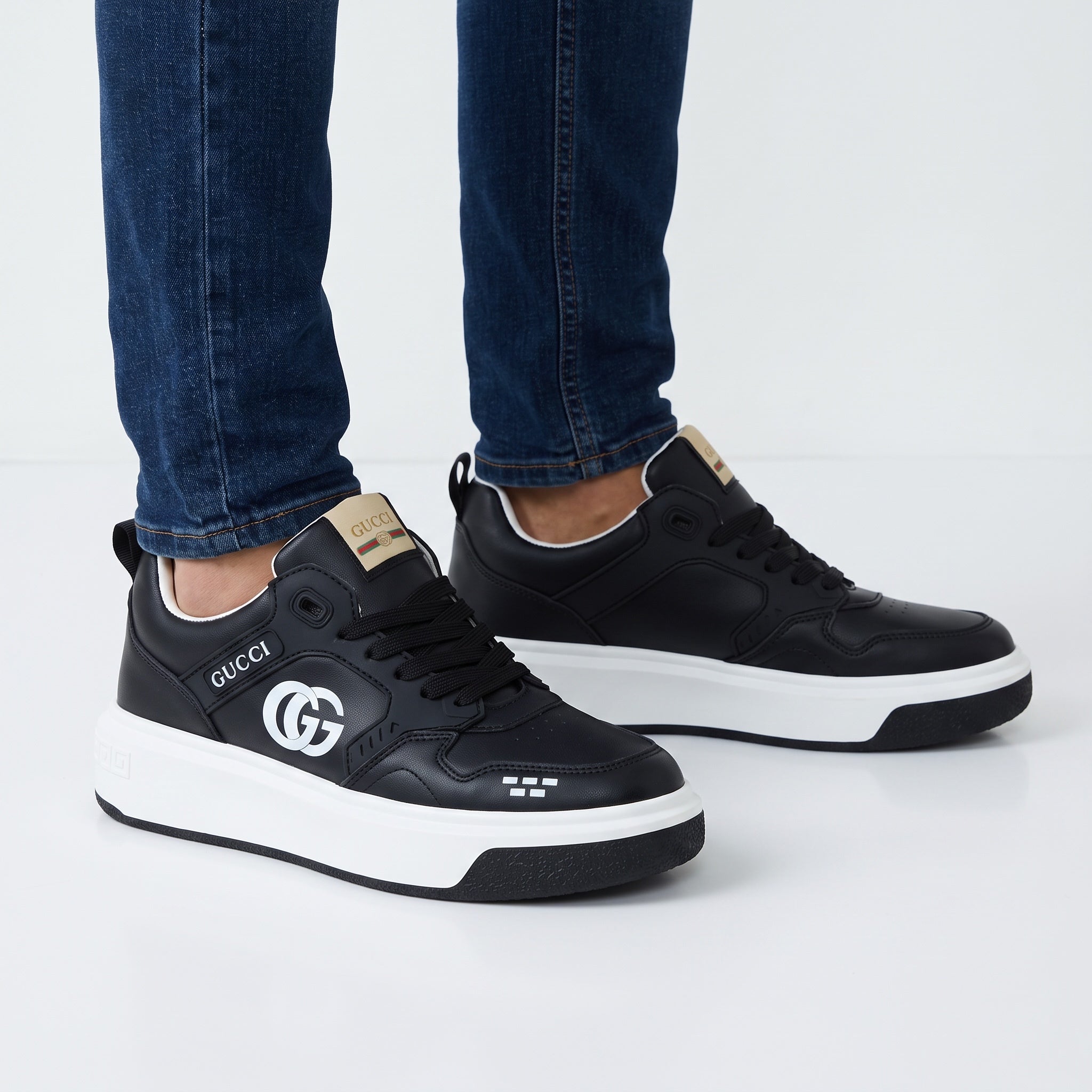 Black Gucci platform sneakers with white sole and GG logo