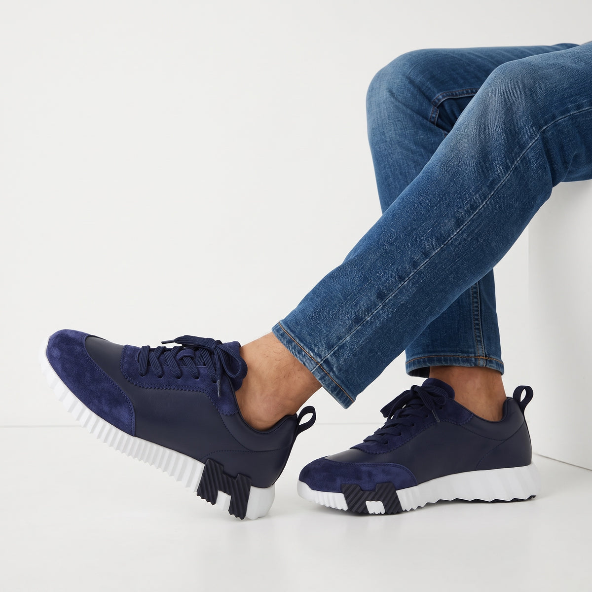 navy low-top sneakers with suede overlays and white ridged sole