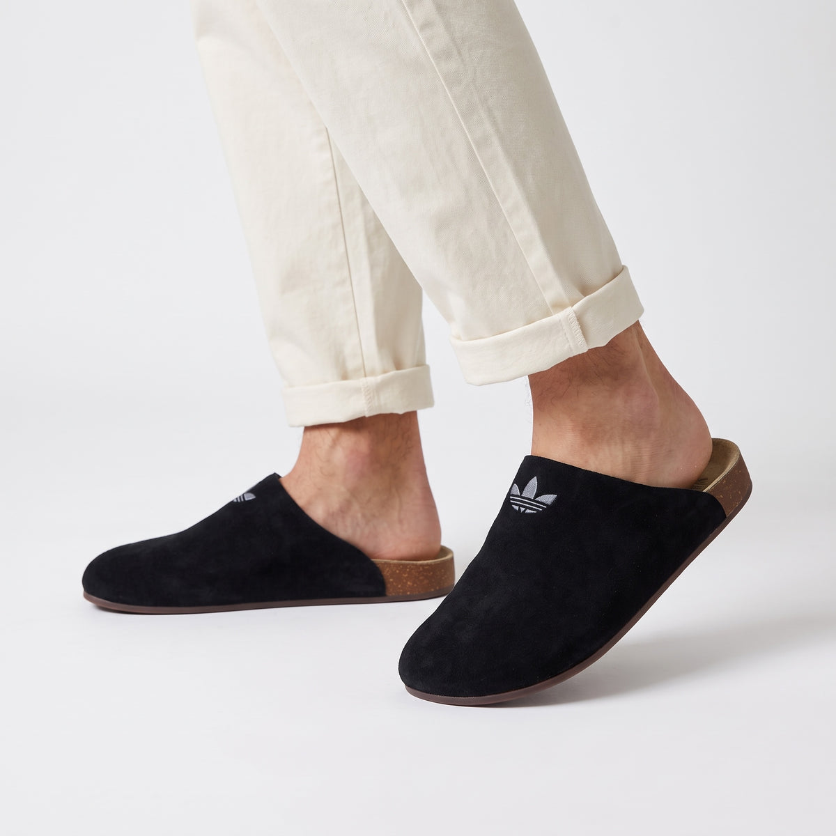 Adidas black slip-on mule with Trefoil logo and cork footbed