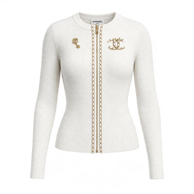 Cream ribbed Chanel zip cardigan with gold chain trim and CC brooch