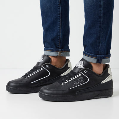 Black Jordan low-top trainers with white accents and signature side graphic
