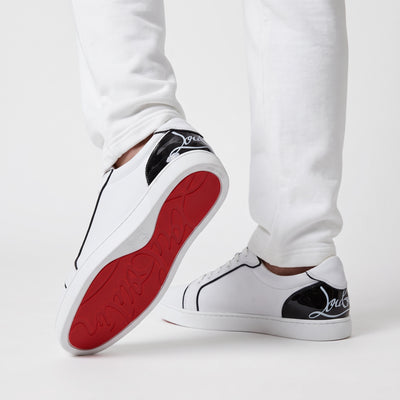 Christian Louboutin white low-top sneakers with black heel tab and red sole