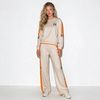 Beige knit two-piece tracksuit with orange side stripes and H logo patches